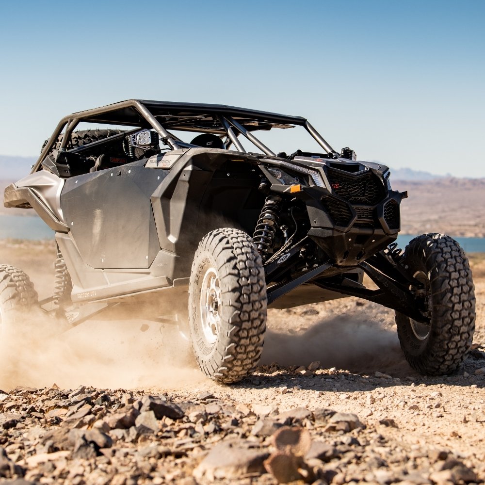 EFX MotoVator R/T UTV tires installed on a UTV driving in desert and rocky terrain.