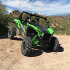 AMS M2 Evil tires mounted on Kawasaki Teryx side-by-side, parked in the western desert on hard pack.