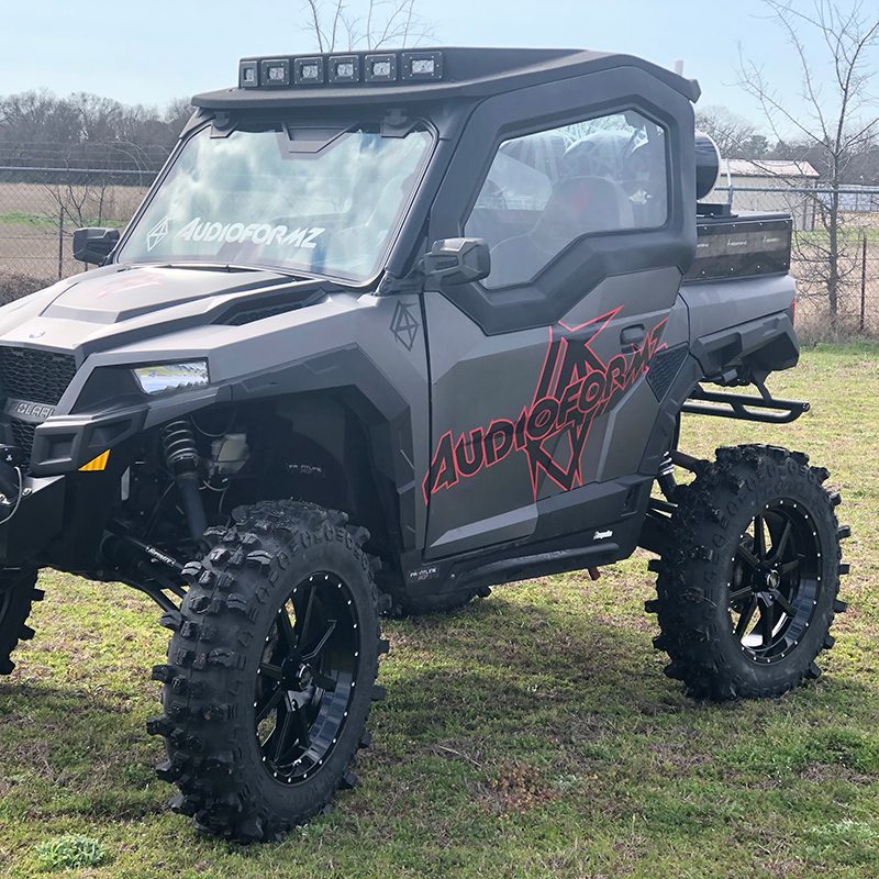 Polaris UTV with Frontline gloss black 556 20" wheels and 35" tall Frontline ACP radial mud/all-terrain tires mounted.