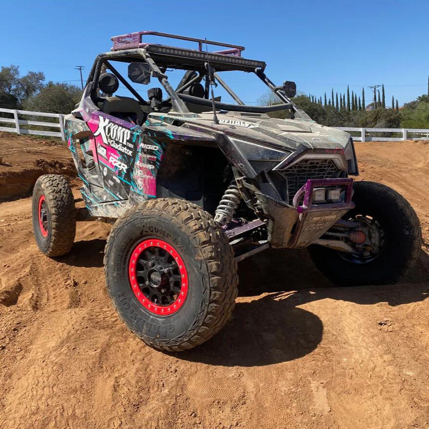 XComp R/S tires mounted on Polaris RZR racing SXS with beadlock 15" rims, parked on race course.