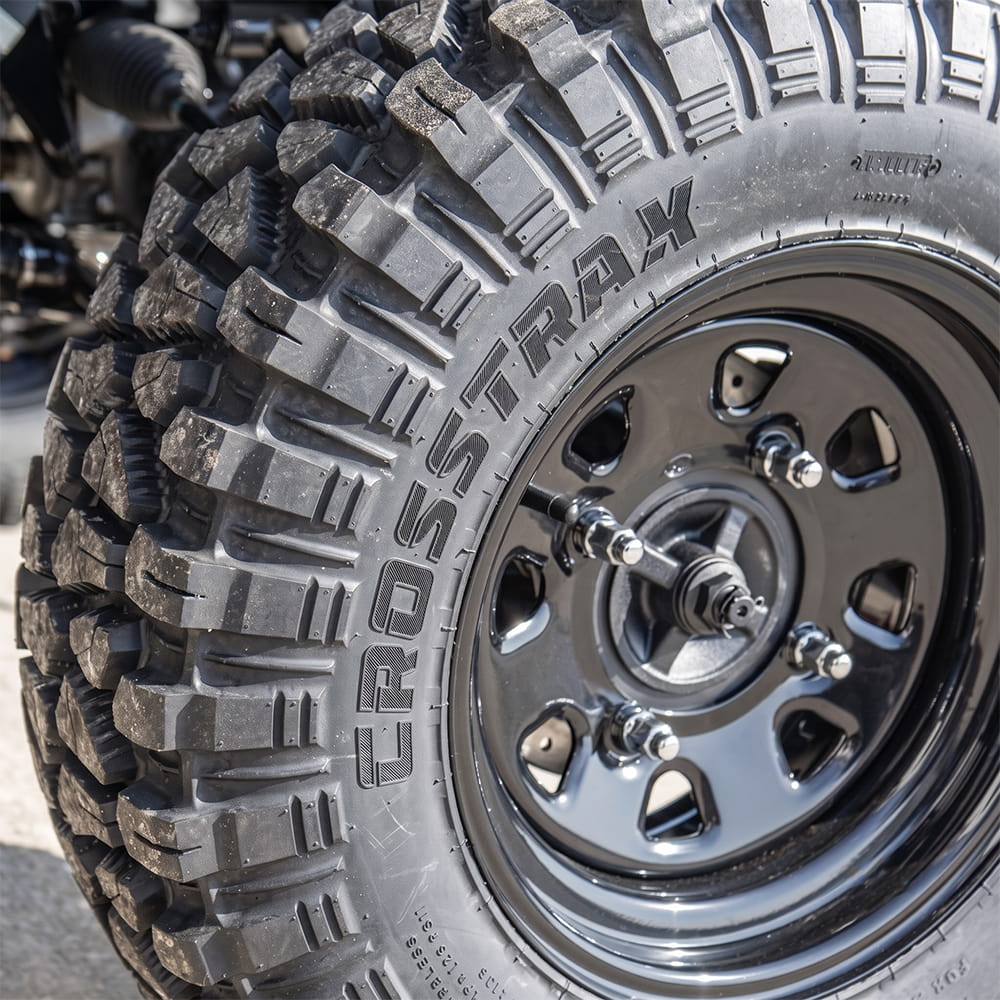 Close up detailed view of the ITP CrossTrax RTV, UTV, and Side-by-Side tire, made with strong 8-ply radial construction, aramid reinforced sidewalls, and long wearing lug design and tread compound, mounted on a rim and sold by authorized dealer Ride or Die Tire.
