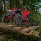Polaris RZR conquering an off road trail with Versa Cross tires installed on custom rims.