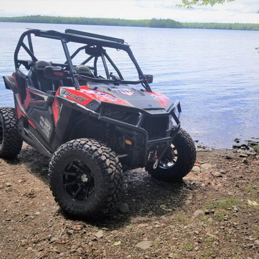 Klever X/T tires installed on Polaris RZR parked beside a beautiful lake.