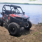 Klever X/T tires installed on Polaris RZR parked beside a beautiful lake.
