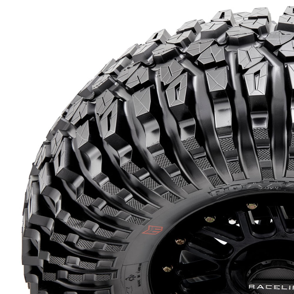 Close up view of the staggered heavy duty shoulder blocks of the Maxxis Roxxzilla standard and comp sticky versions UTV and SXS radial tire.