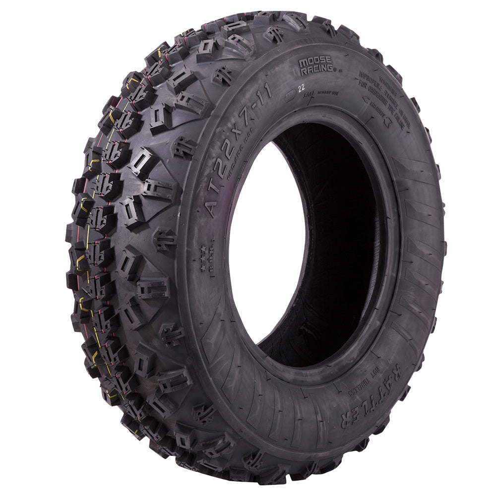Angled view of the Moose Racing Rattler ATV front tire, featuring a high-traction soft rubber compound construction and directional tread pattern, excelling in intermediate and hardpack competition, featuring top steering control, offered with fast and free shipping.