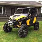 Aggressive Black Mamba Lite ATV/UTV tires mounted on a yellow and black CanAm Maverick 1000R SxS.