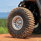 EFX MotoCrusher UTV tire installed on a UTV and covered in dirt
