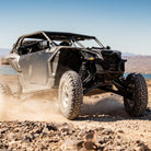 EFX MotoVator R/T UTV tires installed on a UTV driving in desert and rocky terrain.