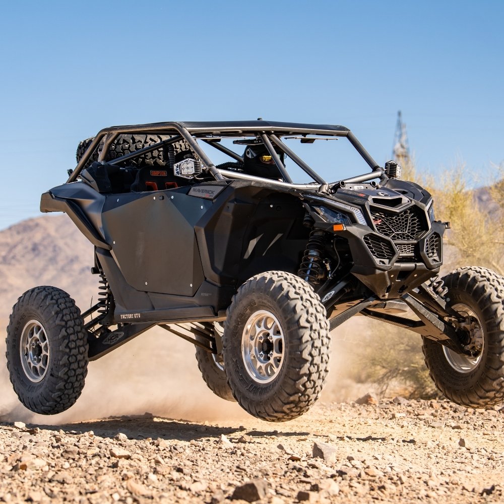 UTV getting slightly airborn driving on rocky terrain with EFX MotoVator R/T UTV tires installed