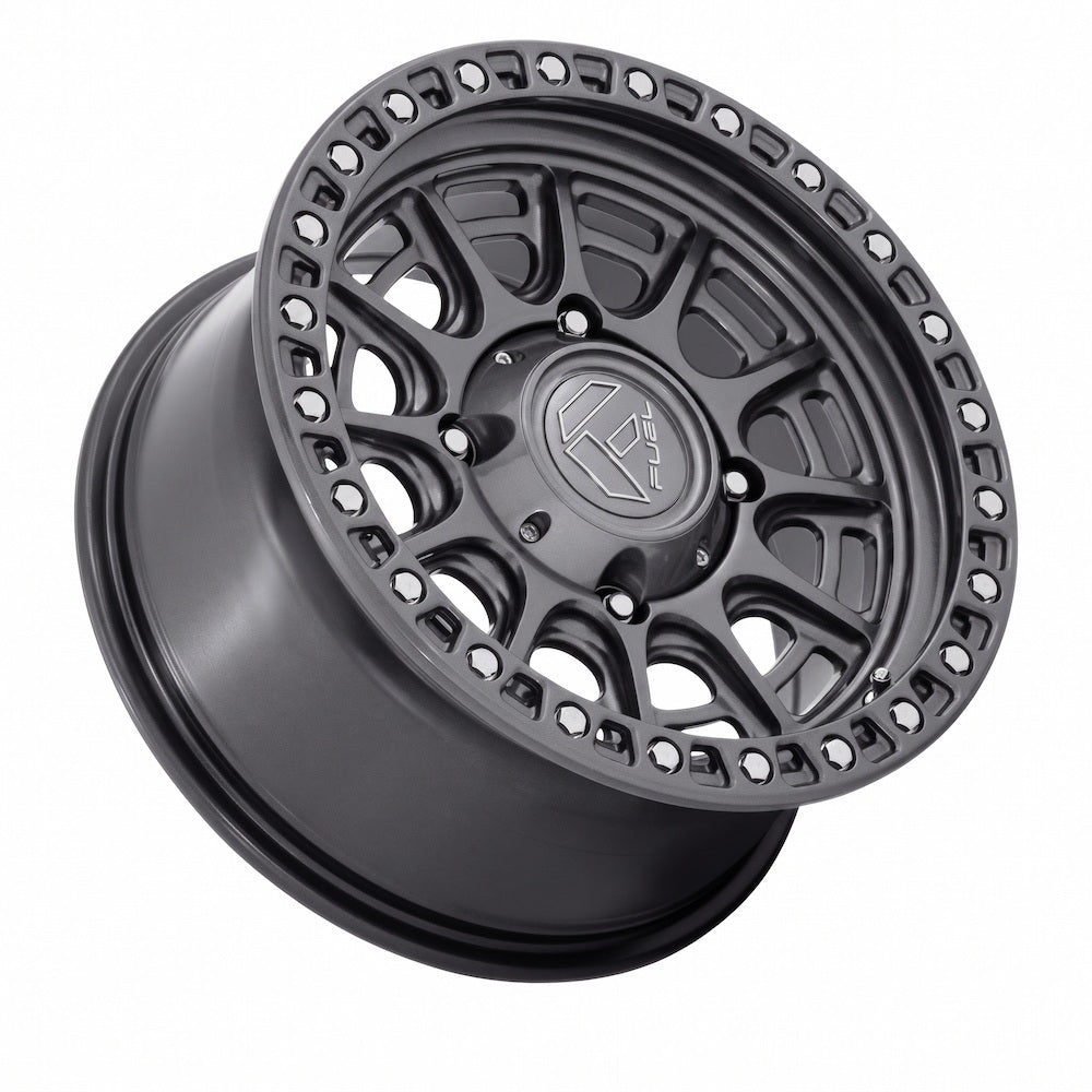 A Fuel Cycle Gloss Gunmetal UTV alloy wheel rim shown at an angle on a solid white background, featuring a visible Fuel logo in the center.
