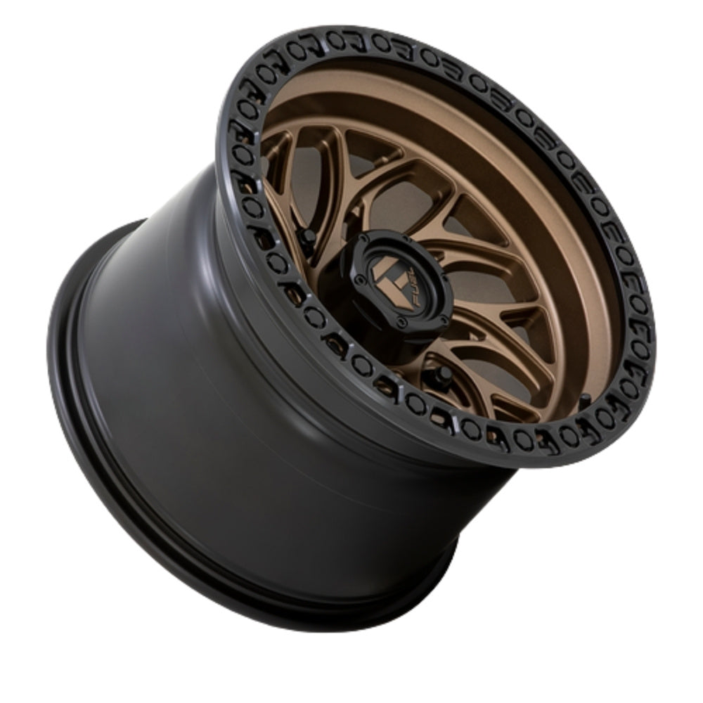 A single Fuel UTV Runner UTV rim shown at an angle on a plain white background. The outer barrel is matte black, and the multi-spoke face is metallic bronze with a black center cap and a ring of small black wheelie pegs around the outer edge.