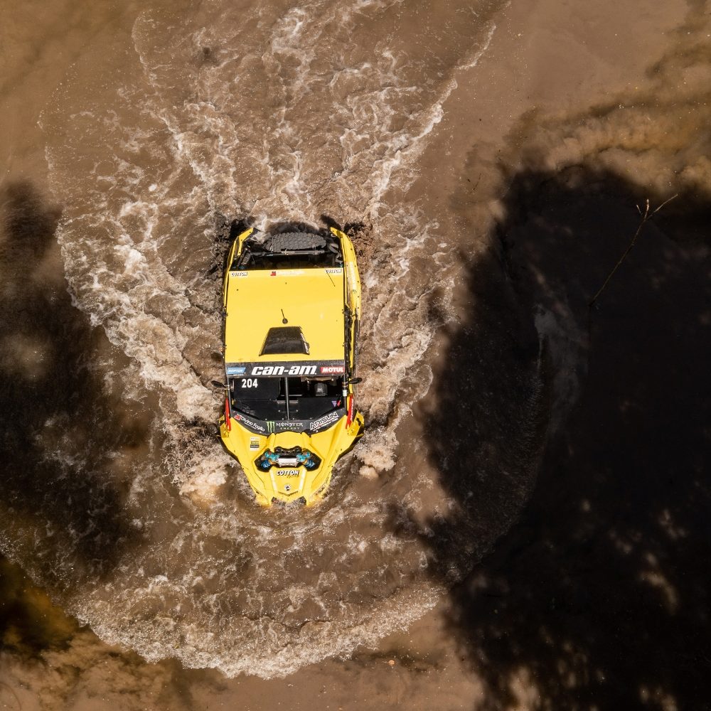 Arial view of a UTV driving through muddy water