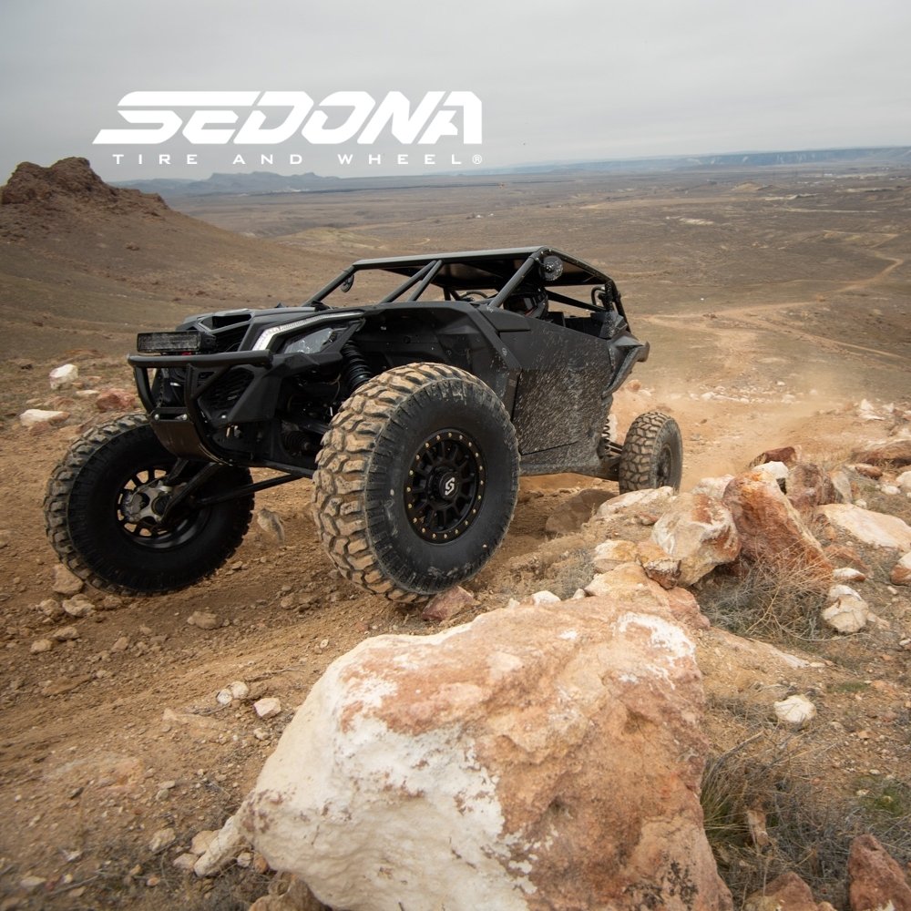 Image of UTV with Sedona Tires driving in mountainous and desert terrain. Sedona Tire & Wheel logo in the overlayed.