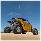 Yellow off-road vehicle on sand with clear blue sky. Tensor sand series tires installed
