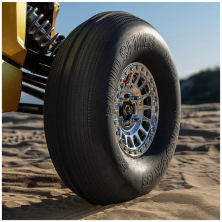 Close up of Tensor sand series front tire installed on a UTV on sand