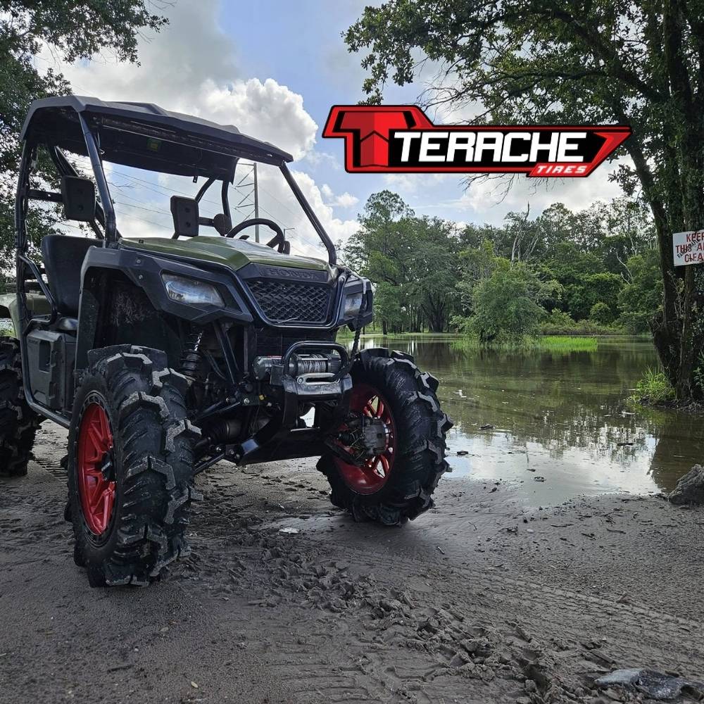 UTV on a muddy terrain with Terache tires and Terache logo in the background