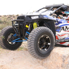 AMS M1 Evil all-terrain UTV radial tires mounted on sxs, driving across rocks, demonstrating the great rock crawling tire ability as well as the rugged construction of the 8-ply radial clamshell construction.