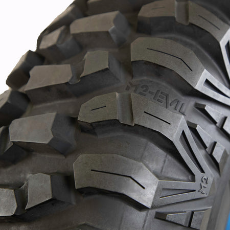 Close up detailed view of the lug design and tread pattern found on the AMS M2 Evil UTV and SXS radial tire with all-terrain performance for mud, sand, rocks, desert, and hard pack surfaces.