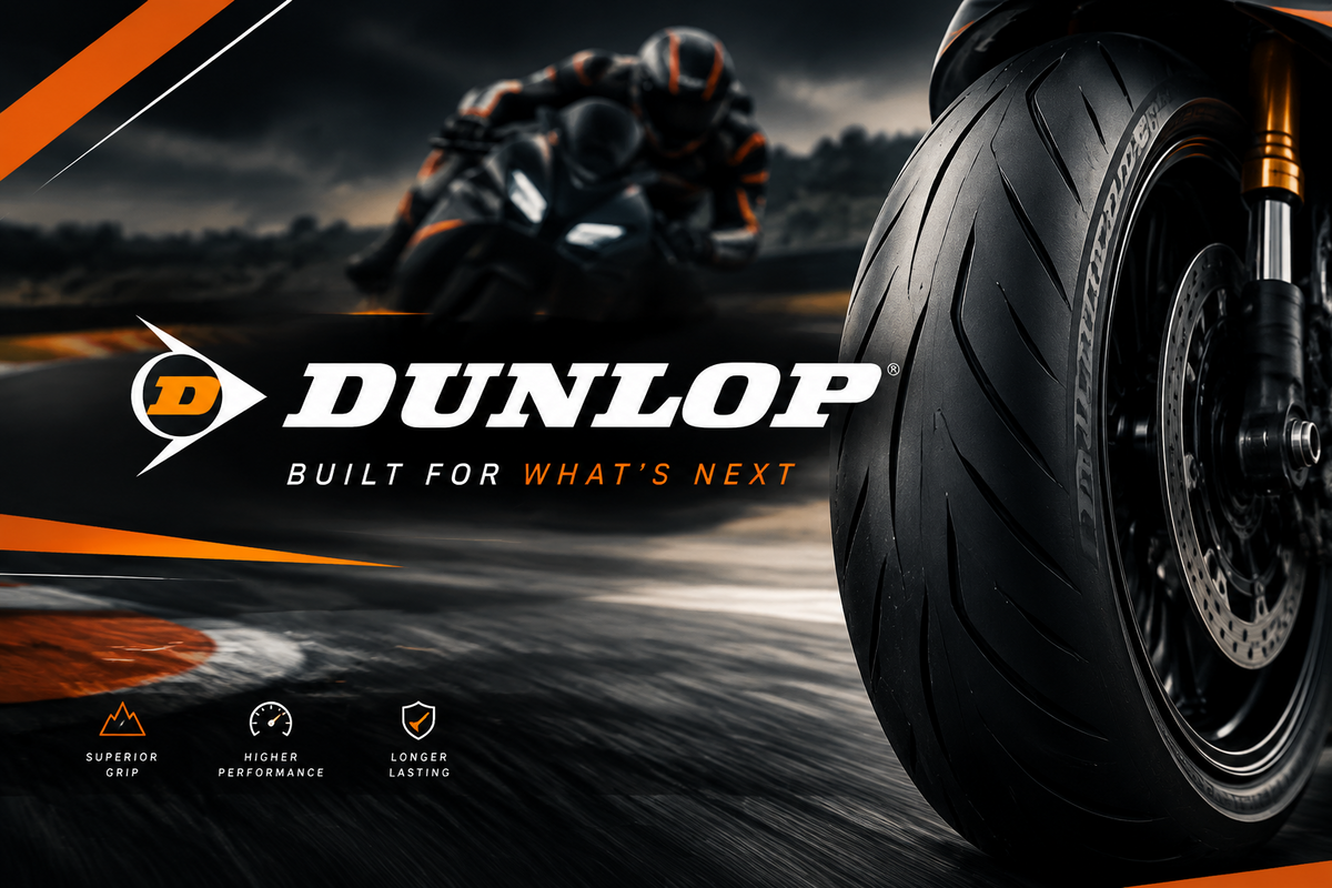 Dunlop motorcycle tire promotional graphic with a close-up of the front wheel on the right, a blurred racer in the background, and the large Dunlop logo with the tagline 'Built for what's next' across the center, main product brand image for Ride or Die Tire's collection of Dunlop motorcycle tires.