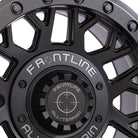 Close up and detailed view of the fit and finish quality on the all new Matte black Frontline 454 Beadlock 15" UTV and SXS wheels, featuring screw-on center cap with Frontline brand logo, and high quality stainless steel beadlock ring bolt hardware.
