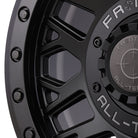 Close up detailed view of the high quality fit and finish on the Frontline 454 beadlock matte black utv and sxs wheel, featuring matte black beadlock rings bolts and screw-on center cap.