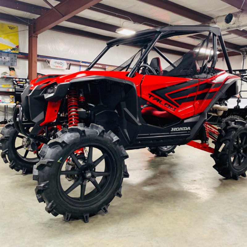 Interforce 628 mud tires mounted on red and black Honda Talon side-by-side.