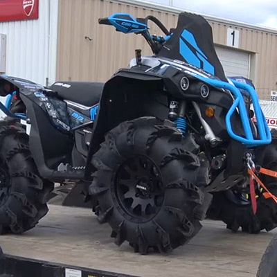 14" Gorilla Silverback tires by Interco mounted on high performance off-road 4x4 quad, parked on a trailer.
