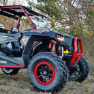 Interco Reptile Radial tires installed on Polaris RZR side-by-side in woods.