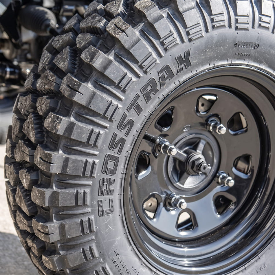 Close up detailed view of the ITP CrossTrax RTV, UTV, and Side-by-Side tire, made with strong 8-ply radial construction, aramid reinforced sidewalls, and long wearing lug design and tread compound, mounted on a rim and sold by authorized dealer Ride or Die Tire.