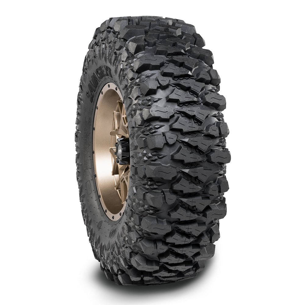 The ITP Savage XT HARC tire mounted on ITP rim and inflated with a drop shadow underneath the tire.