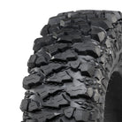 Close up detailed view of the tread pattern and lug design of the ITP Savage X/T all-terrain and rock crawling extreme UTV tire featuring wide spaced shoulder lugs and aggressive rock grabbing sidewalls with extra strong sidewalls, offered in 9 popular and unique sizes.