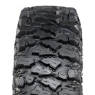 Close up detailed view of the multi-angled lug design and non-directional tread pattern of the Savage XT tire, including diamond textured casing profile between the lugs to promote mud self-cleaning and enhance grip in all conditions, and triangle stepped lug bases to eliminate dirt and mud build-up between the center lugs.