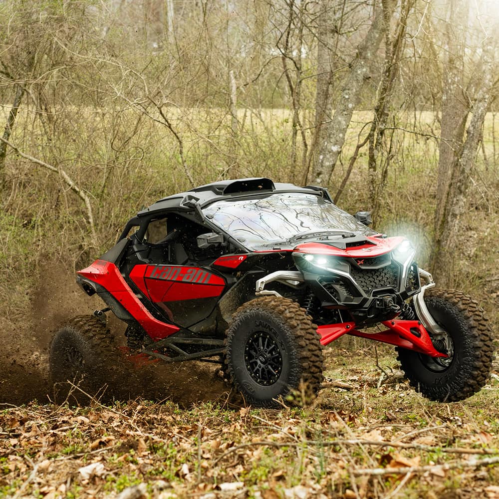 Can-Am Maverick R mounted with Savage XT tires and wheels, drifting through a cornfield in Tennessee.