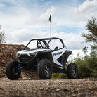 Tenacity tires installed on Polaris RZR with a blue sky backdrop.