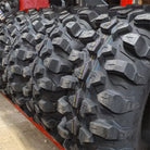 A row of brand new high performance rock crawling, mud terrain Kenda Warhawk K3214 Side-by-side UTV tires, ready to be purchased and put to the test.