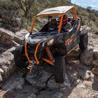 Can-am Side-by-side descending rocky terrain with Maxxis Liberty UTV tires installed.