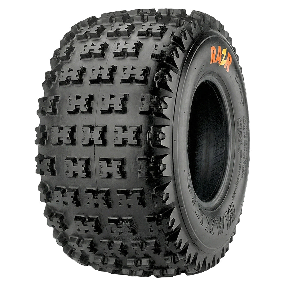 Angled view of the competition Maxxis RAZR ATV / Quad rear tire, featuring a high traction "x" lug design with flat profile and tread contact base to enhance acceleration and braking responsiveness, offered with fast and free shipping and available in a wide variety of popular Quad tire sizes.