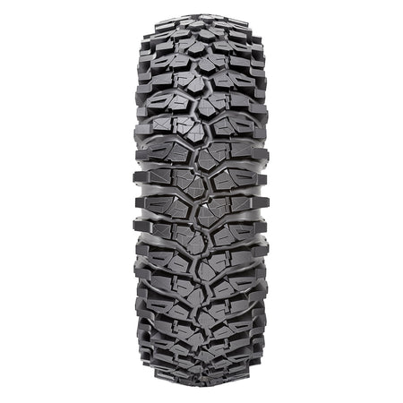 Detailed view of the aggressive rock crawling tread pattern and tread block lug design of the 8-ply standard and competition sticky Maxxis Roxxzilla UTV and SXS radial tire, featuring alternating staggered shoulder lugs for rock traction.