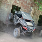 Brand new Odyssey Force Blaster UT tires mounted on RZR, riding the trail and climbing a wall in Kentucky, featuring great traction on rocks, mud, and trail.