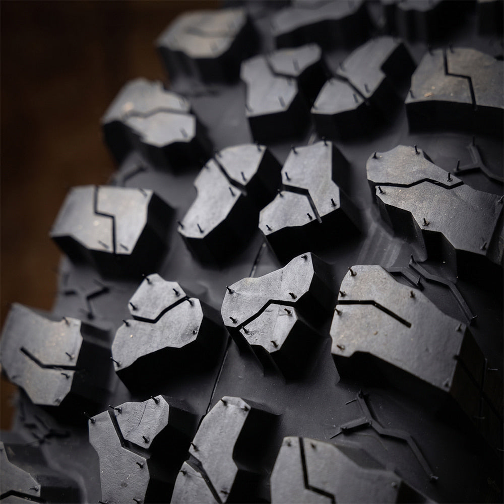 Close up detailed high definition view of the tread block design, inter-lug casing texture for cleanout, of the new Odyssey Force Conqueror 8-ply nylon radial aggressive all-terrain UTV and SXS tire, available in a wide variety of sizes.