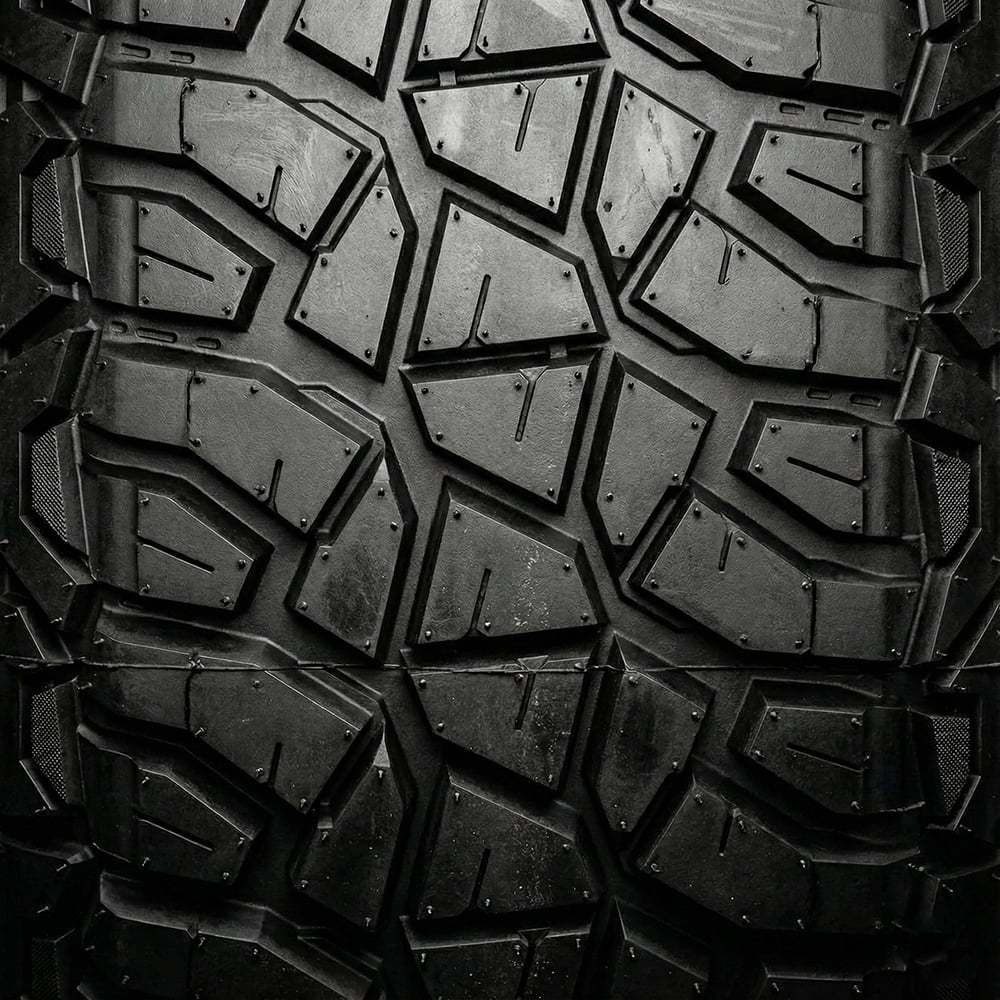 Close up detailed tread pattern view and lug features found on the Valor Tango line of premium UTV tires, showcasing segmented mold construction for ultimate handling, ride, and control, as well as stepped lug bases and staggered shoulder lug design.