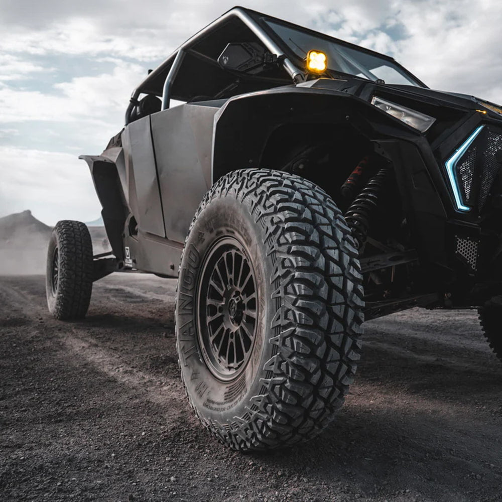 32x9.50R15 Tango UTV 8-ply SBR tire mounted on Polaris Turbo S parked out in the desert.