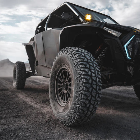 32x9.50R15 Tango UTV 8-ply SBR tire mounted on Polaris Turbo S parked out in the desert.