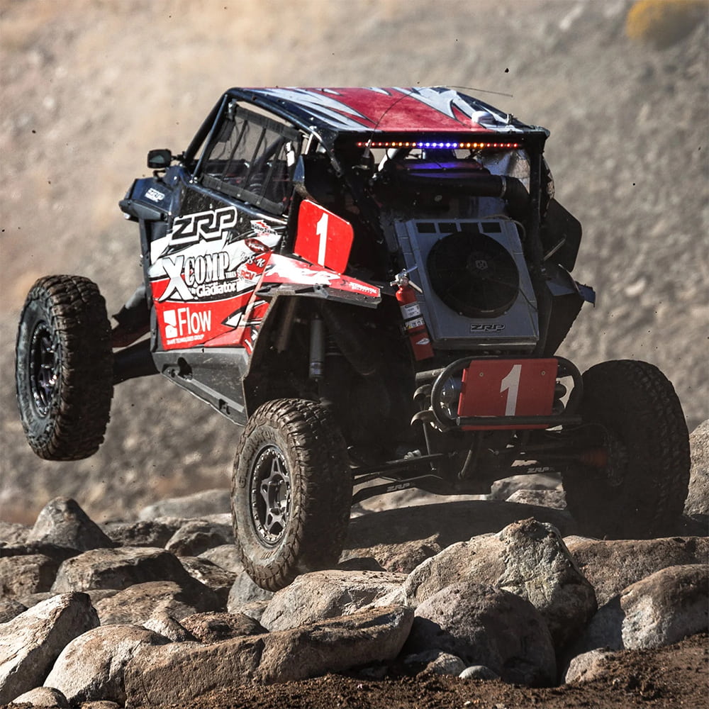 Gladiator Xcomp ATR tires racing through a rocky portion of a desert race course.